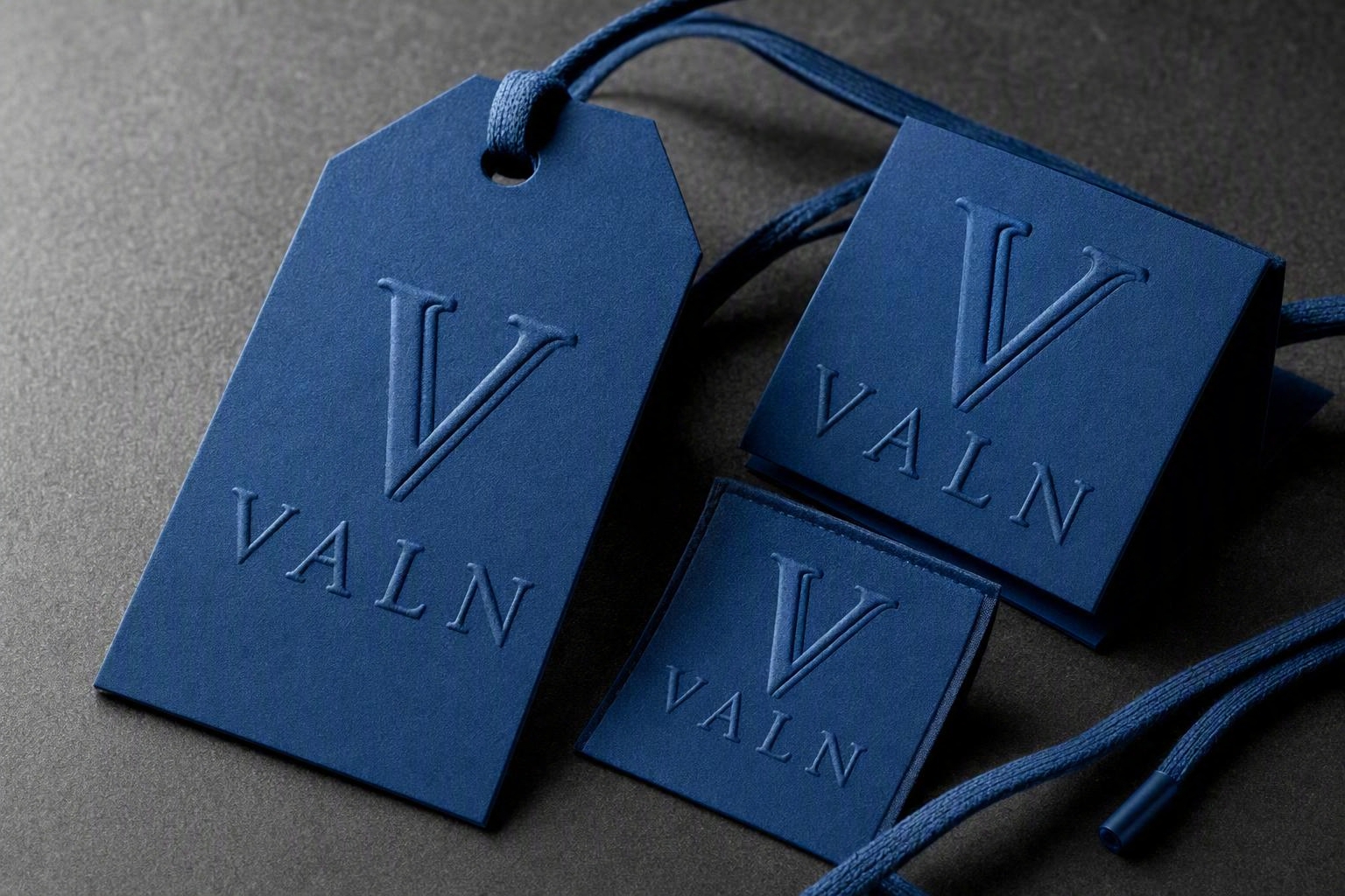 VALN raised-embossed hang tags and garment labels